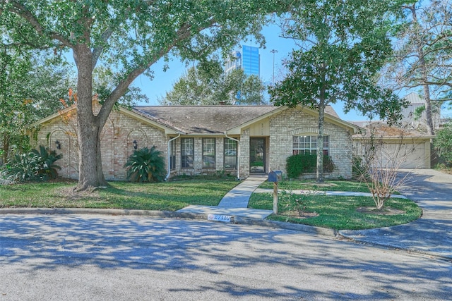 ranch-style home with a garage and a front lawn