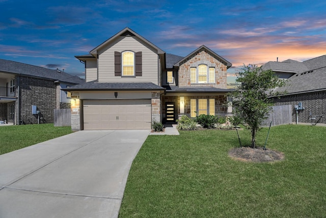 view of front of house with a garage and a yard