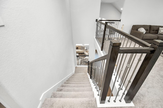 staircase featuring lofted ceiling