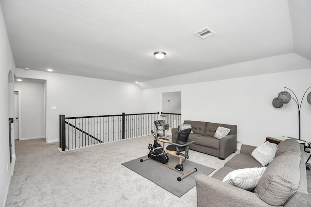 workout room featuring vaulted ceiling and light colored carpet