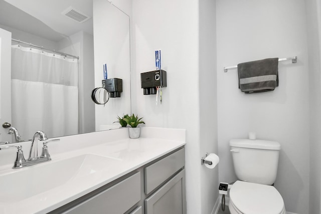 bathroom with toilet and vanity