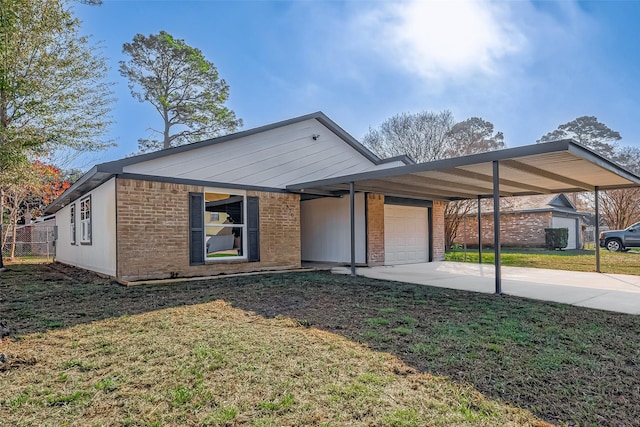 view of front of house featuring a front yard, a garage, and a carport