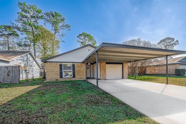 view of front of property featuring a carport, a garage, and a front yard