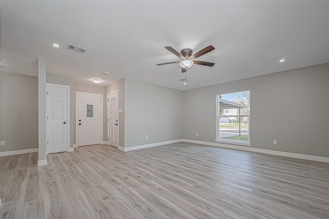 empty room featuring ceiling fan and light wood-type flooring