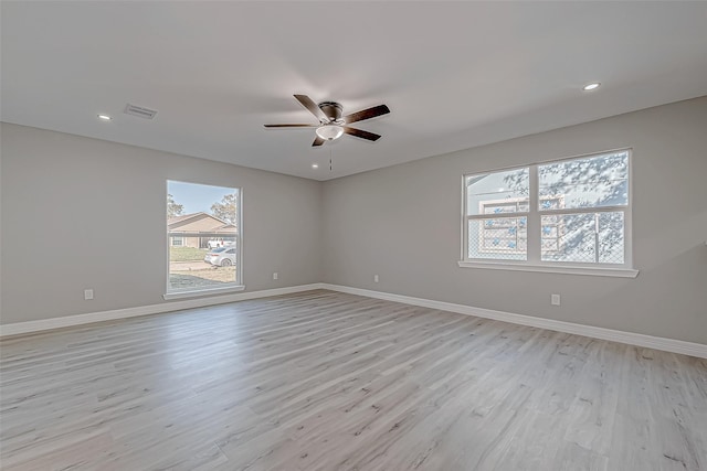 spare room featuring light hardwood / wood-style flooring and ceiling fan