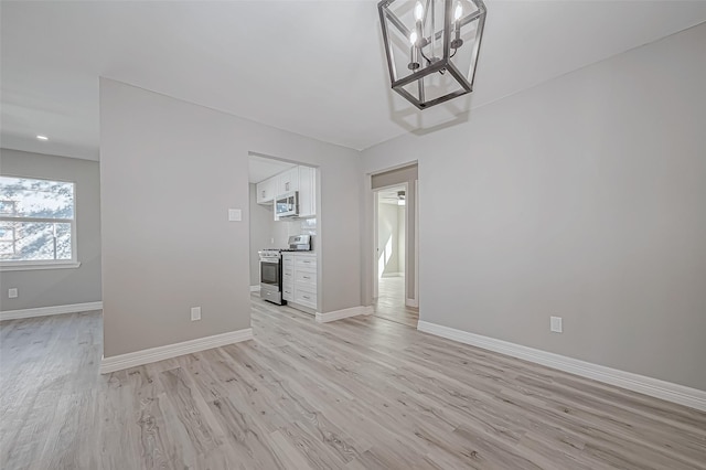 interior space featuring a notable chandelier and light hardwood / wood-style floors