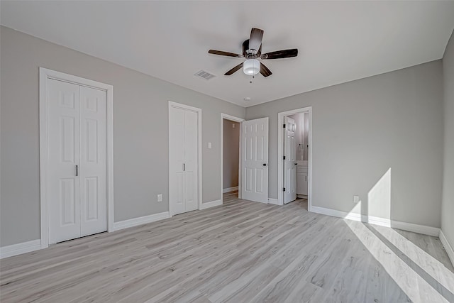 unfurnished bedroom with ensuite bath, ceiling fan, and light hardwood / wood-style floors