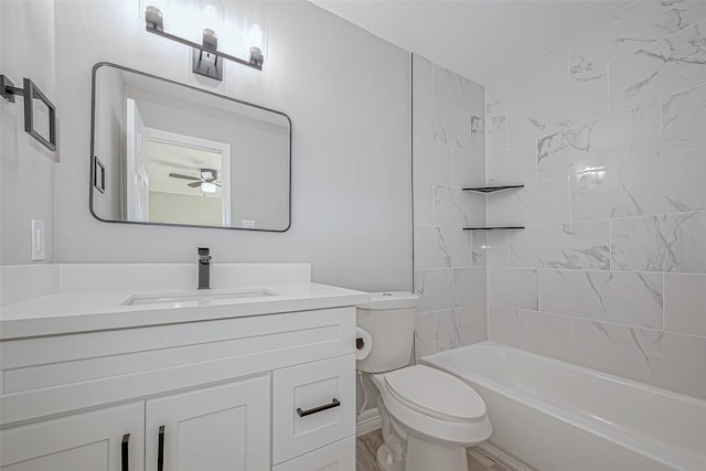 full bathroom featuring ceiling fan, toilet, vanity, and tiled shower / bath