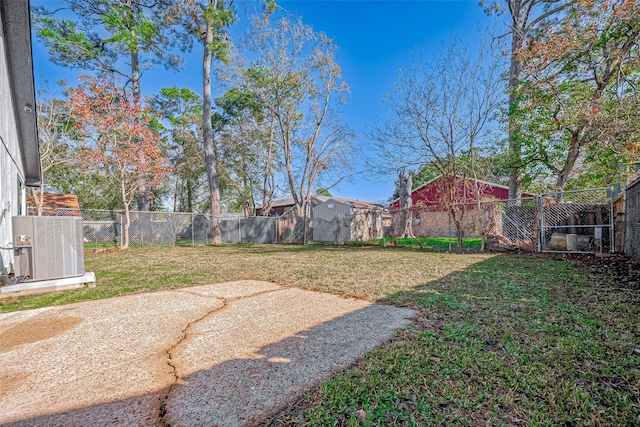 view of yard with central AC unit and a patio area