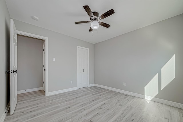 unfurnished bedroom with light wood-type flooring, a closet, and ceiling fan