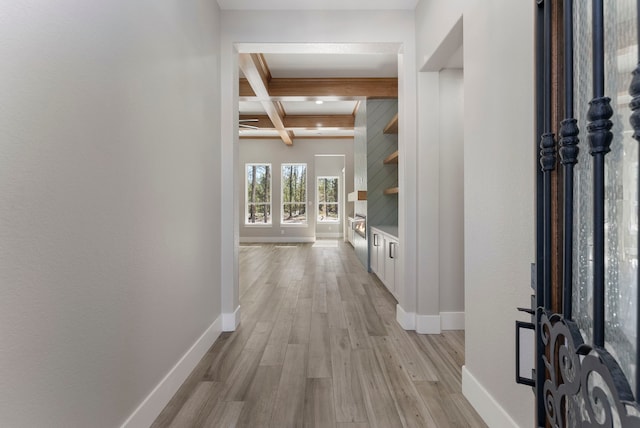 hall with beamed ceiling, light hardwood / wood-style floors, and coffered ceiling