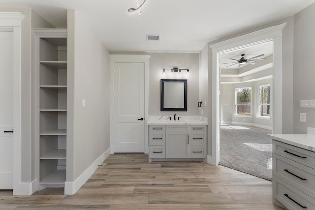 bathroom featuring ceiling fan and vanity