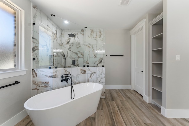 bathroom with shower with separate bathtub and hardwood / wood-style flooring