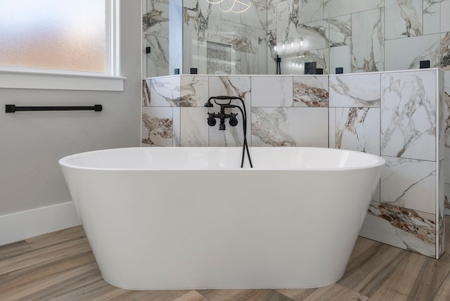 bathroom with hardwood / wood-style floors and independent shower and bath