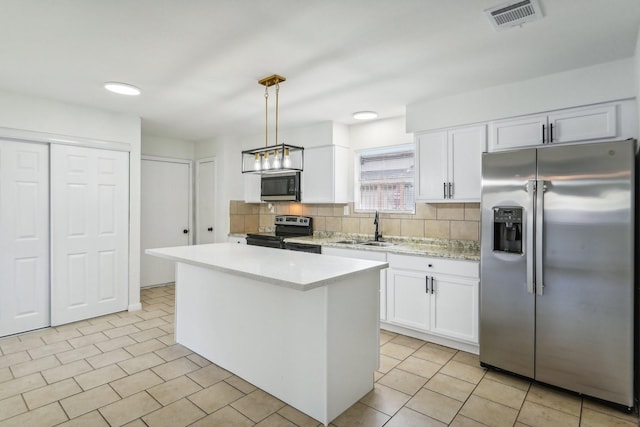 kitchen with white cabinetry, pendant lighting, a kitchen island, and stainless steel appliances