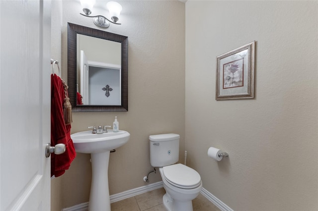 bathroom with toilet and tile patterned floors