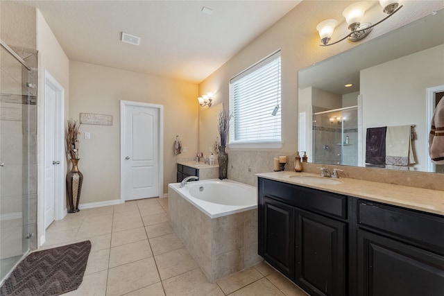 bathroom with plus walk in shower, vanity, and tile patterned floors