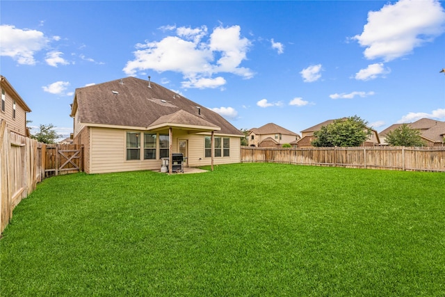 rear view of house featuring a lawn and a patio area