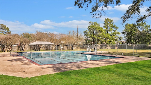 view of pool with a lawn