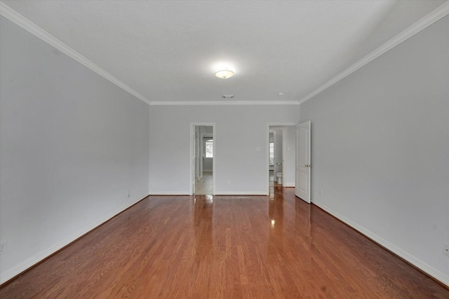 unfurnished room featuring wood-type flooring and ornamental molding