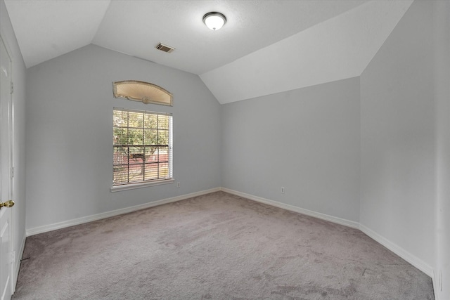 bonus room featuring light colored carpet and vaulted ceiling