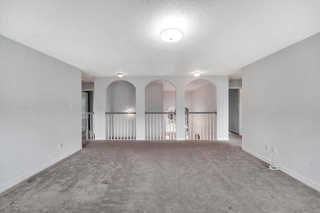 carpeted spare room featuring a textured ceiling