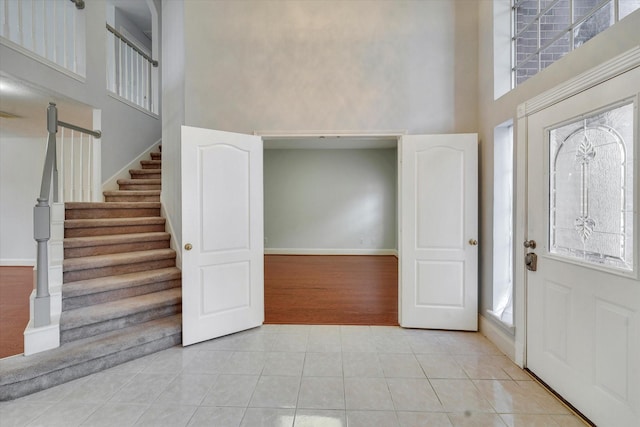 tiled foyer entrance featuring a high ceiling