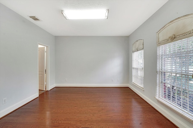 empty room featuring dark wood-type flooring