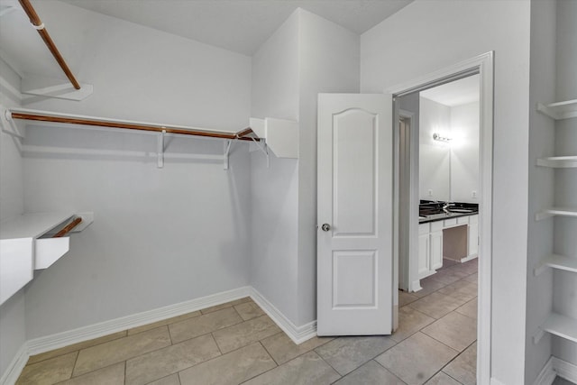 spacious closet featuring light tile patterned floors