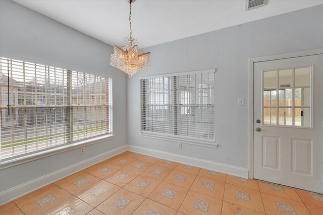 unfurnished dining area featuring light tile patterned floors and a chandelier