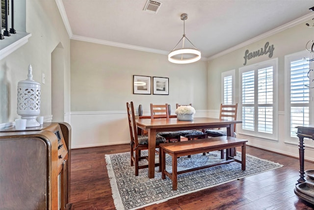 dining space featuring dark hardwood / wood-style flooring and ornamental molding