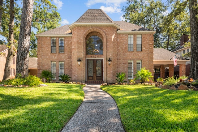 view of front of property featuring a front lawn and french doors