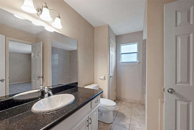 bathroom featuring tile patterned floors, vanity, and toilet