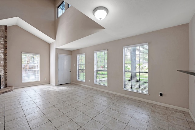 spare room featuring a fireplace and light tile patterned floors