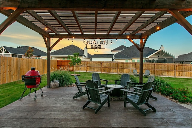 patio terrace at dusk with a pergola and a lawn