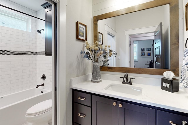 full bathroom featuring vanity, a healthy amount of sunlight, toilet, and tiled shower / bath