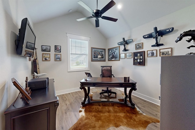 home office featuring light wood-type flooring, vaulted ceiling, and ceiling fan