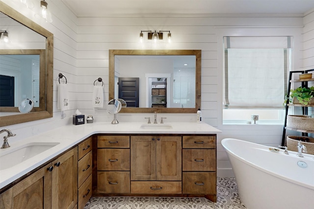 bathroom featuring a tub to relax in, tile patterned floors, wooden walls, and vanity