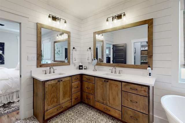 bathroom with a tub, wood walls, and vanity