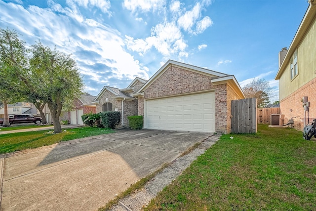 view of front of home with a front yard, central AC, and a garage