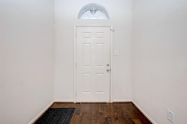 entryway with dark hardwood / wood-style flooring