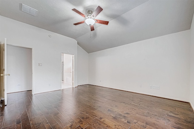 unfurnished room featuring vaulted ceiling, ceiling fan, a textured ceiling, and dark hardwood / wood-style floors