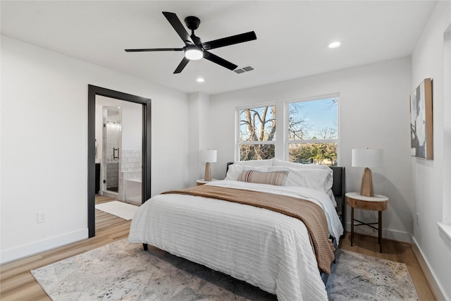 bedroom featuring ceiling fan, light wood-type flooring, and connected bathroom