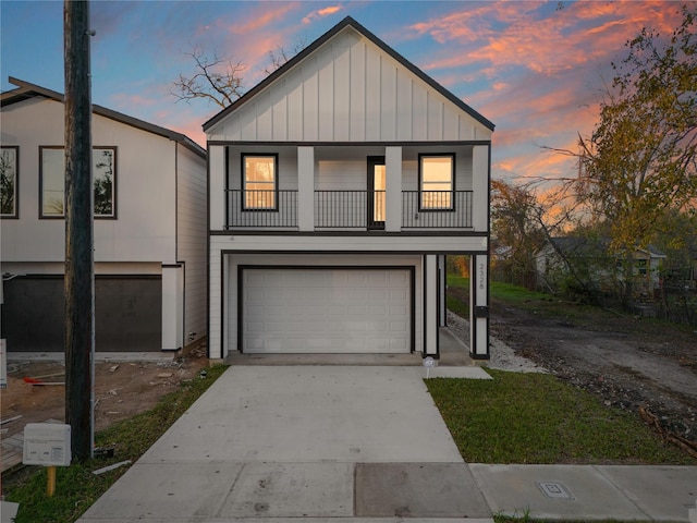 view of front of property featuring a balcony and a garage