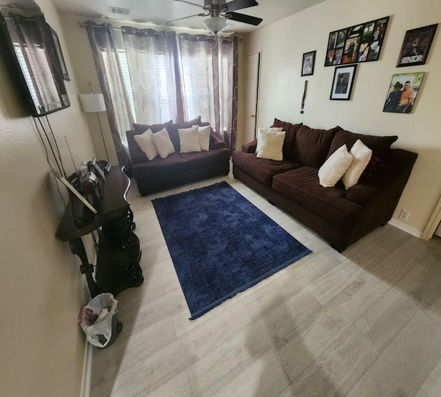 living room featuring ceiling fan and light wood-type flooring