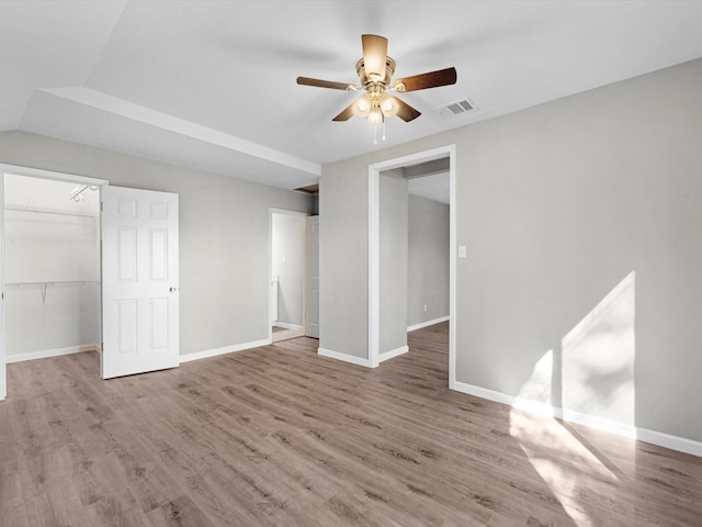 interior space with a closet, vaulted ceiling, ceiling fan, and light hardwood / wood-style floors