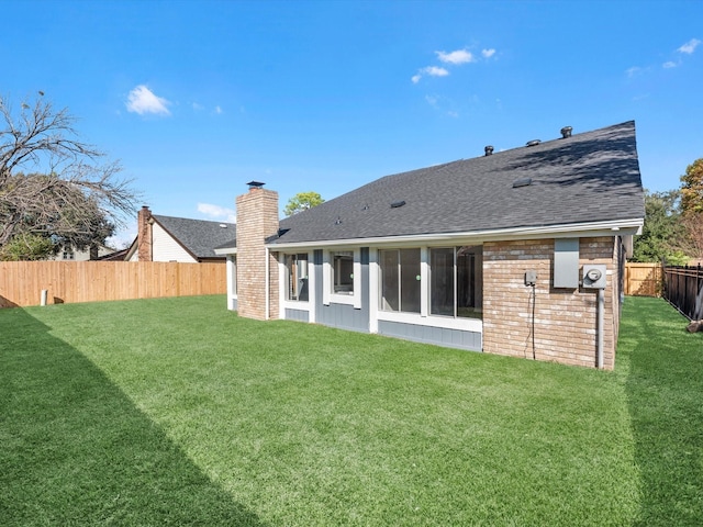 rear view of house with a lawn