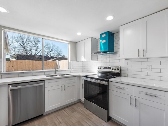 kitchen featuring white cabinets, appliances with stainless steel finishes, and sink