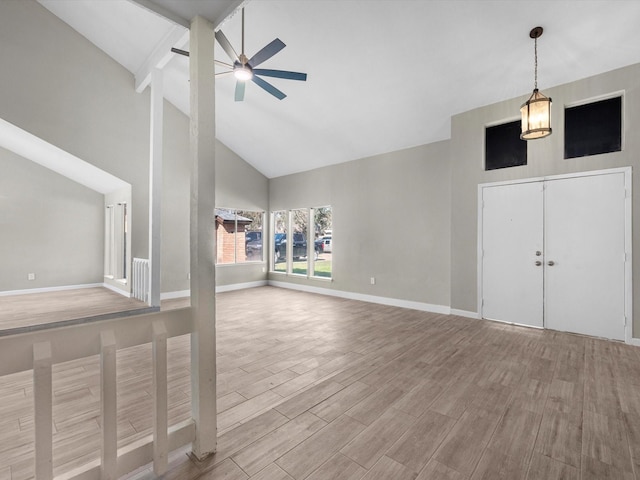 unfurnished living room with ceiling fan, light hardwood / wood-style flooring, and high vaulted ceiling