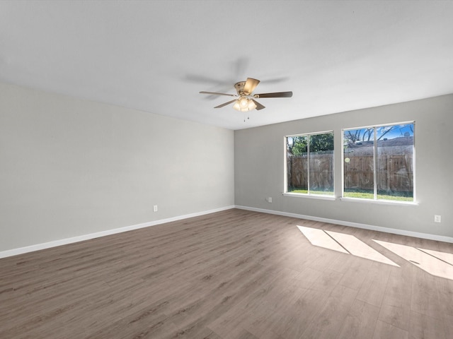 unfurnished room with ceiling fan and wood-type flooring